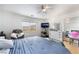 This bedroom features a white headboard, wood floors, and an exterior view of the surrounding scenery at 10143 Canyon Hills Ave, Las Vegas, NV 89148