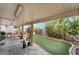 Backyard covered patio with slate tile and artificial grass at 10143 Canyon Hills Ave, Las Vegas, NV 89148