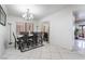 Bright dining room features chandelier, dining table, decorative mirror, and access to other parts of the house at 10143 Canyon Hills Ave, Las Vegas, NV 89148