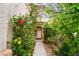 Inviting entryway surrounded by lush greenery and colorful flowering plants at 10143 Canyon Hills Ave, Las Vegas, NV 89148