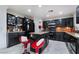 Modern kitchen with dark cabinetry, granite countertops, island, and stainless steel appliances at 10143 Canyon Hills Ave, Las Vegas, NV 89148