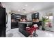 Modern kitchen with dark cabinetry, granite countertops, island, and stainless steel appliances at 10143 Canyon Hills Ave, Las Vegas, NV 89148