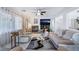 Cozy living room has a fireplace, large windows, comfortable sofas, ceiling fan, and decor at 10143 Canyon Hills Ave, Las Vegas, NV 89148