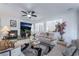 Living room features a fireplace, comfortable seating, ceiling fan, and large TV for entertainment at 10143 Canyon Hills Ave, Las Vegas, NV 89148