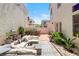 Enclosed backyard featuring an outdoor seating area with a patio and a stone walkway at 10276 Cherry Brook St, Las Vegas, NV 89183