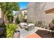 Private backyard featuring outdoor furniture, a built-in grill and bar, all surrounded by lush greenery at 10276 Cherry Brook St, Las Vegas, NV 89183