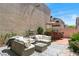 Inviting backyard featuring a paved patio with a lounge area and outdoor bar with a grill, perfect for entertaining at 10276 Cherry Brook St, Las Vegas, NV 89183