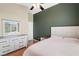 Bright bedroom featuring hardwood floors, a ceiling fan, and a dresser with mirror at 10276 Cherry Brook St, Las Vegas, NV 89183