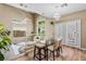 Bright dining area featuring a glass table set, modern lighting, and a view of the upstairs seating area at 10276 Cherry Brook St, Las Vegas, NV 89183