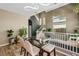 Open dining area with a glass table set, view of stairs and upstairs seating area with a comfortable sofa at 10276 Cherry Brook St, Las Vegas, NV 89183