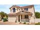 Charming two-story home featuring a tile roof, front porch, well-maintained landscaping, and an attached two-car garage at 10276 Cherry Brook St, Las Vegas, NV 89183
