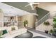 Open-concept living room featuring stairs, view into kitchen, modern decor, and tons of natural light at 10276 Cherry Brook St, Las Vegas, NV 89183