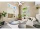 Bright living room featuring vaulted ceilings, large windows, modern furnishings, and stylish decor at 10276 Cherry Brook St, Las Vegas, NV 89183