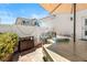 Outdoor kitchen with built in grill and countertop under the shade of a patio umbrella at 10276 Cherry Brook St, Las Vegas, NV 89183