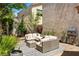 Relaxing patio area with comfortable seating, a patterned rug, and views of well-maintained landscaping at 10276 Cherry Brook St, Las Vegas, NV 89183