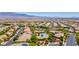 Expansive aerial view showcases the neighborhood's layout, amenities, and the surrounding scenic landscape and mountain views at 10631 Kennedy Peak Ln, Las Vegas, NV 89166