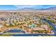 An aerial view of the neighborhood shows the community center and pool with the mountains in the distance at 10631 Kennedy Peak Ln, Las Vegas, NV 89166