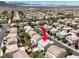 This is an aerial view of the neighborhood showing the home, indicated with a red arrow at 10631 Kennedy Peak Ln, Las Vegas, NV 89166