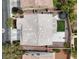 An aerial view shows the gray tiled roof, desert landscaping, and outdoor play area of the beautiful home at 10631 Kennedy Peak Ln, Las Vegas, NV 89166
