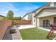 This backyard features artificial turf, a gravel area, a patio, and a block wall at 10631 Kennedy Peak Ln, Las Vegas, NV 89166