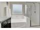 Clean and modern bathroom featuring a soaking tub, separate shower, and sleek vanity at 10631 Kennedy Peak Ln, Las Vegas, NV 89166