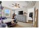 This bedroom features a dresser with a TV on top, a ceiling fan, decorated walls, and closet access at 10631 Kennedy Peak Ln, Las Vegas, NV 89166