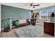 Bonus room featuring a ceiling fan, workout equipment, and cozy decor at 10631 Kennedy Peak Ln, Las Vegas, NV 89166