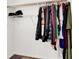 This closet has clothes hanging, a shelf for storage, and carpeted flooring at 10631 Kennedy Peak Ln, Las Vegas, NV 89166