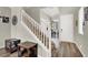 Foyer with staircase and wood flooring, showcasing entry door and interior design elements at 10631 Kennedy Peak Ln, Las Vegas, NV 89166