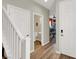 Hallway with staircase leading to upper floor, with doors visible and wood flooring at 10631 Kennedy Peak Ln, Las Vegas, NV 89166