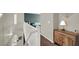 Hallway featuring a white staircase, modern cabinet, and neutral wall color at 10631 Kennedy Peak Ln, Las Vegas, NV 89166