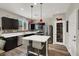 Modern kitchen with dark cabinets, quartz countertops, stainless steel appliances, and breakfast bar at 10631 Kennedy Peak Ln, Las Vegas, NV 89166