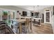 Modern eat-in kitchen with stainless steel appliances, dark cabinetry, and plenty of counter space at 10631 Kennedy Peak Ln, Las Vegas, NV 89166