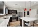 Stylish kitchen featuring stainless steel appliances, dark cabinetry, and quartz countertops at 10631 Kennedy Peak Ln, Las Vegas, NV 89166
