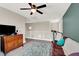 Open loft area with plush carpet, ceiling fan, and comfortable furnishings at 10631 Kennedy Peak Ln, Las Vegas, NV 89166
