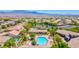 Community pool with lush landscaping and lounge areas, offering a perfect space for relaxation and recreation at 10631 Kennedy Peak Ln, Las Vegas, NV 89166