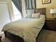 Bedroom with full bed, ceiling fan, a nightstand and dresser, and warm-colored walls at 1121 Majestic Canyon St, Henderson, NV 89052