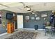 Finished garage as a Personal cave with TV and automotive themed wall decor at 1121 Majestic Canyon St, Henderson, NV 89052