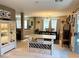 Open concept with kitchen island flowing into dining area with stylish decor and ample seating at 1121 Majestic Canyon St, Henderson, NV 89052