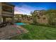 Backyard featuring a pool, manicured lawn, landscaping, and covered patio area at 11944 Dolcemente Ln, Las Vegas, NV 89138
