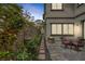 Backyard features brick wall with a statue, climbing roses, seating area, and fire pit at 11944 Dolcemente Ln, Las Vegas, NV 89138