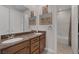 Bathroom with double sinks, framed mirrors, and a separate shower and toilet area at 11944 Dolcemente Ln, Las Vegas, NV 89138