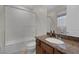 Bathroom featuring a shower-tub combo with a frosted glass door and a single sink vanity at 11944 Dolcemente Ln, Las Vegas, NV 89138