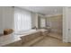 Beautifully designed bathroom featuring soaking tub and walk-in shower with neutral tiling at 11944 Dolcemente Ln, Las Vegas, NV 89138