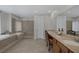 Large, neutral-toned bathroom featuring double sinks, tiled floors, soaking tub and walk-in shower at 11944 Dolcemente Ln, Las Vegas, NV 89138