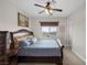 Bedroom with ceiling fan, carpeted floors, and large window bringing in natural light at 11944 Dolcemente Ln, Las Vegas, NV 89138