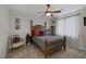 Bedroom features wooden furniture, a ceiling fan, and cozy decor with carpeted floor at 11944 Dolcemente Ln, Las Vegas, NV 89138