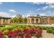 Inviting community entrance with colorful flowers and manicured landscaping at 11944 Dolcemente Ln, Las Vegas, NV 89138