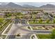 Scenic community view featuring well-kept homes, green spaces, and mountain backdrop at 11944 Dolcemente Ln, Las Vegas, NV 89138