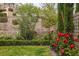 Lush garden featuring colorful roses, manicured hedges, and trees, creating a serene outdoor retreat at 11944 Dolcemente Ln, Las Vegas, NV 89138